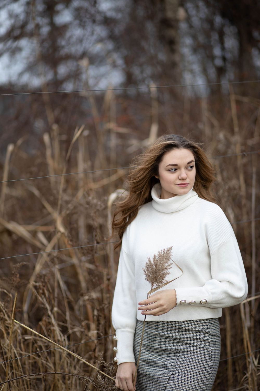 Portrait of a beautiful girl standing in front of pampas grass
