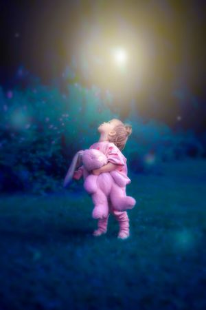Dreamy outdoor scene with pink clothing creates a magical twilight atmosphere.