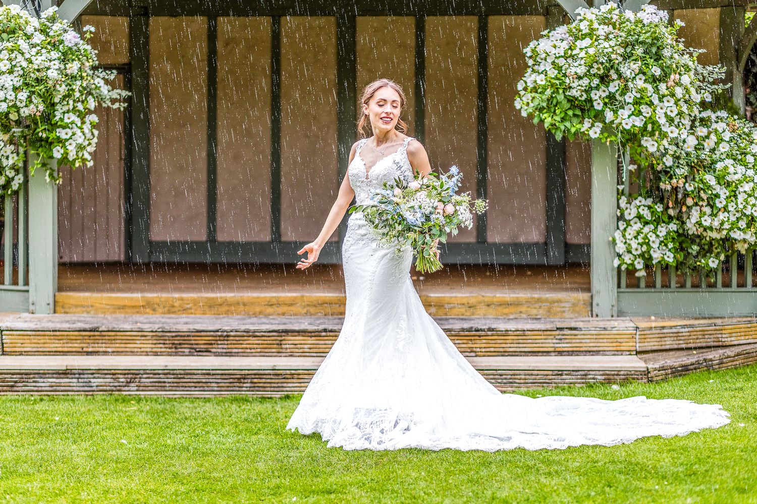 A Beautiful Bride in the rain getting married at Cooling Castle Barn Wedding