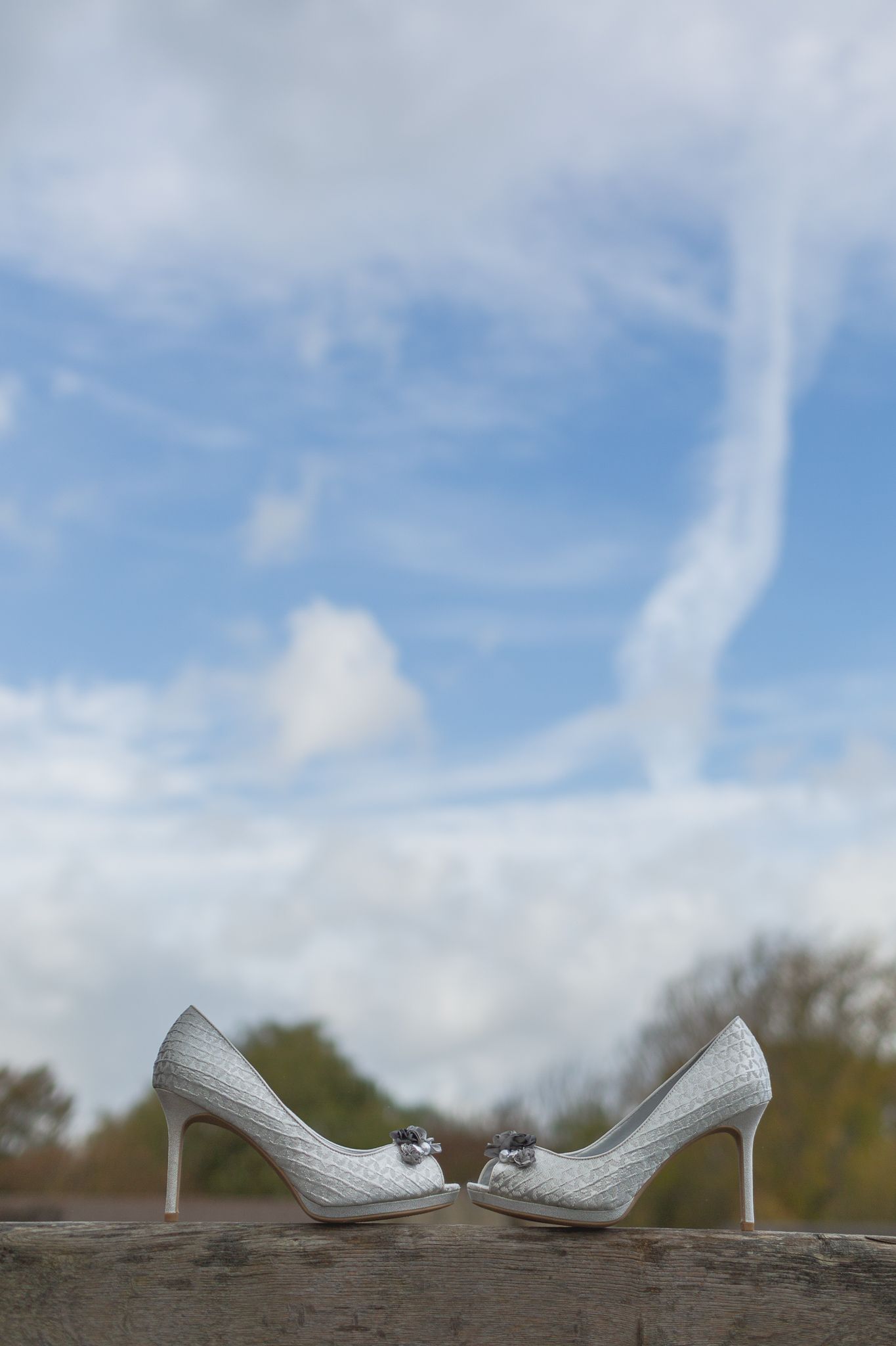 Photography of Wedding Shoes at Cooling Castle Barn with a stunning sky