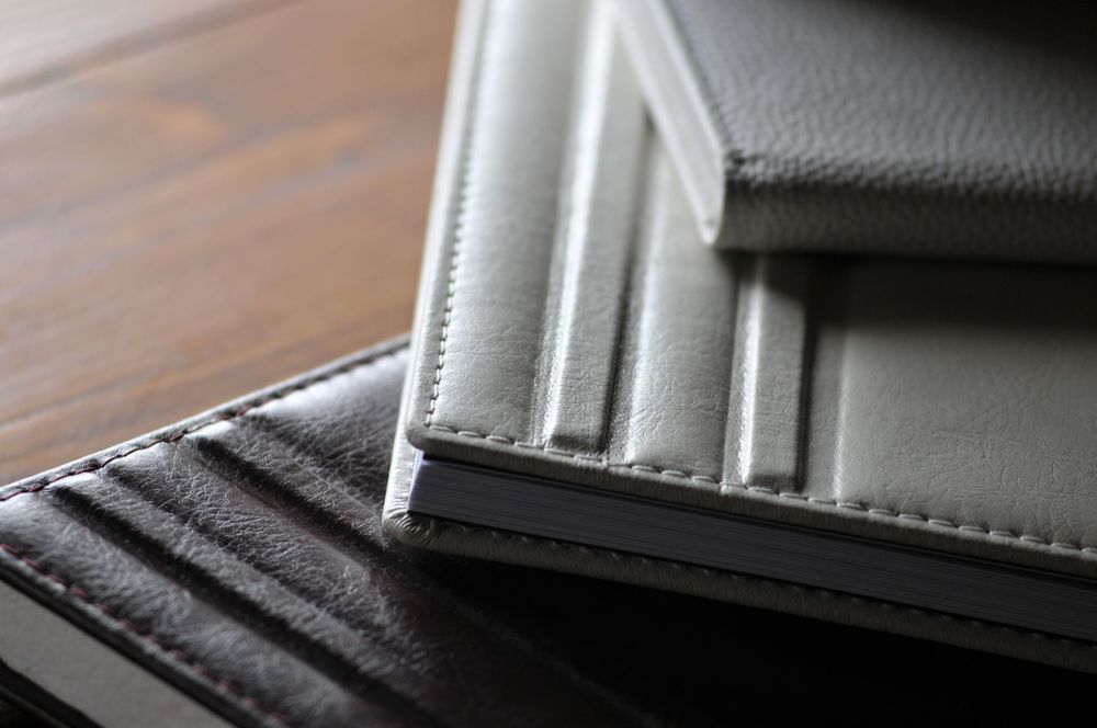 Close-up view of two leather wallets showing detail of the stitched edges and card slots.