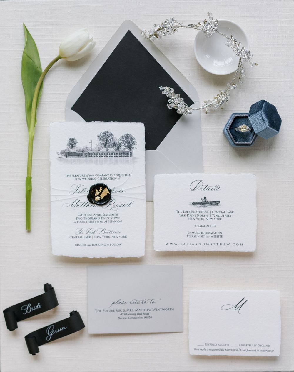 Wedding invitation suite with a tulip flower, vintage rings, and delicate floral details.