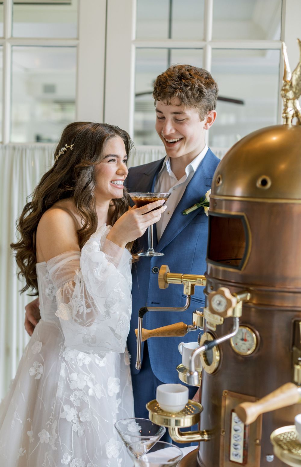 Elegant vintage brass coffee machine serves wedding guests in bright sunlit venue.