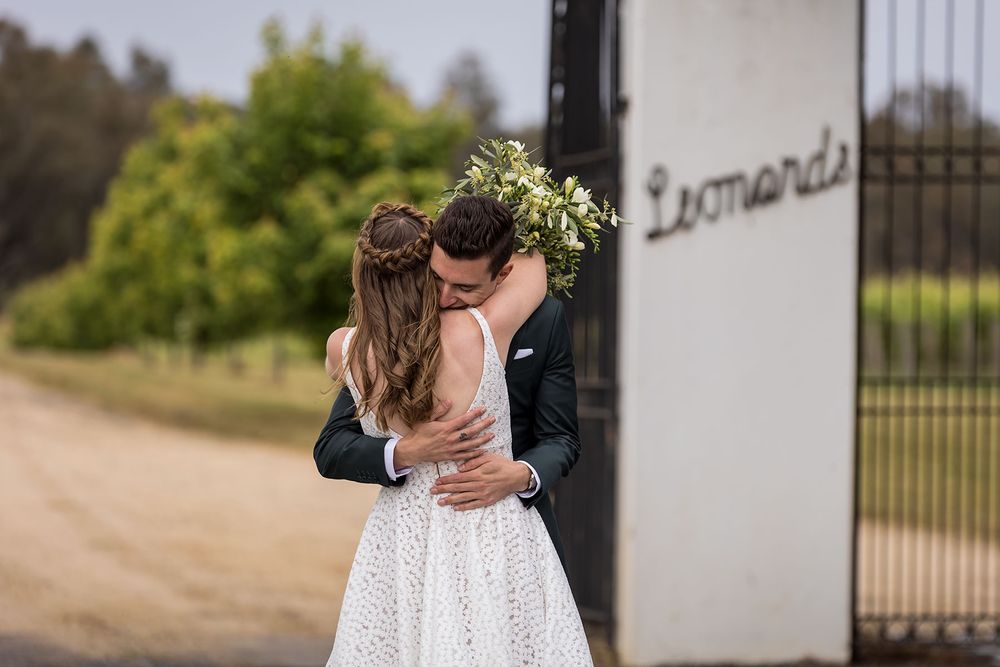 Bride and Groom hugging at the gates of St.Leonards Vineyard before their wedding ceremony at St.Leonards Vineyard