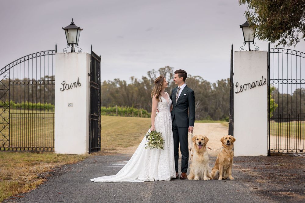 Bride and Groom sharing a moment together with their Golden Retriever dogs before their wedding ceremony at St.Leonards