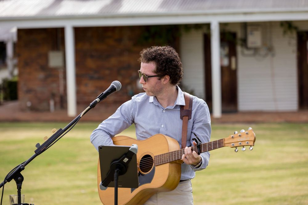 Musician playing the guitar during a wedding ceremony at St.Leonards Vineyard