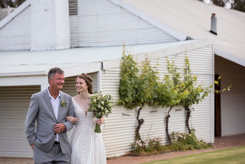 Dad walking his daughter down the aisle into her outdoor ceremony at St.Leonards Vineyard