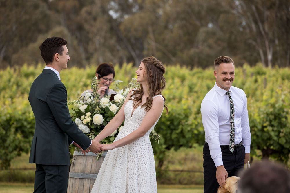 Bride and Groom sharing a moment together as they exchange their vows during their wedding ceremony at St.Leonards