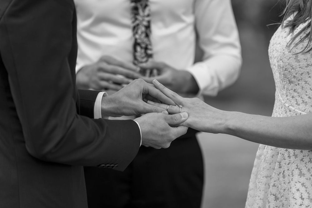 Bride and Groom sharing a moment together as they exchange their wedding rings during their wedding ceremony