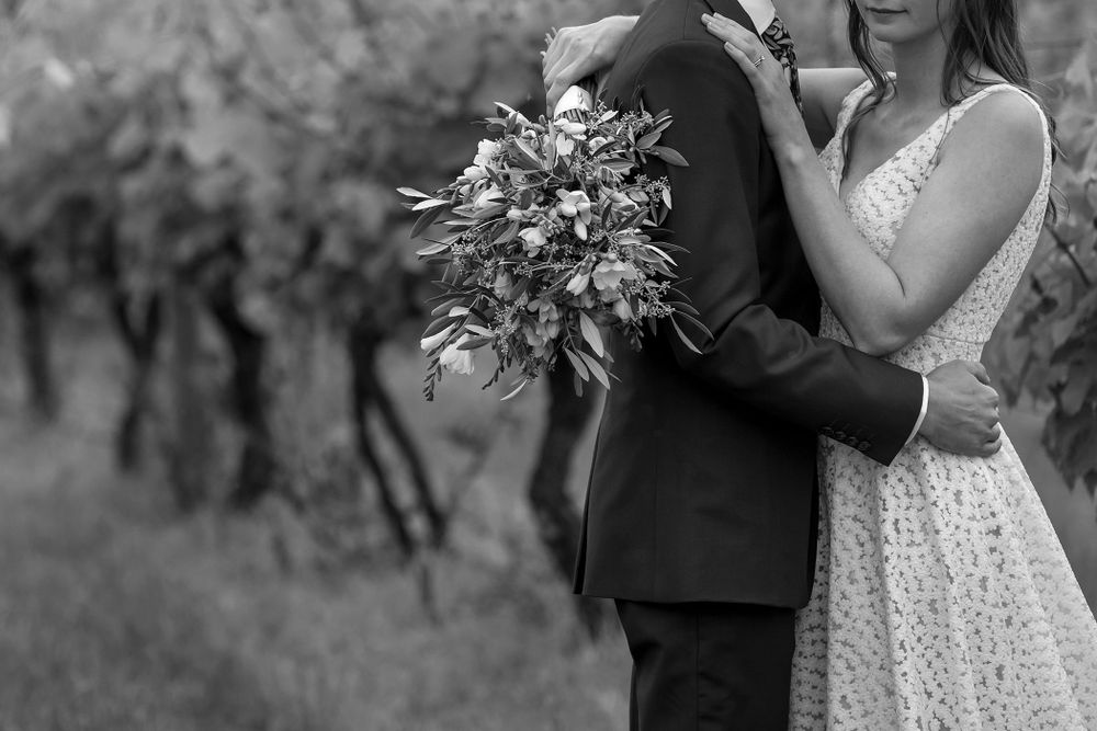 Bride and Groom sharing a moment together in the vines after their wedding ceremony at St.Leonards Vineyard