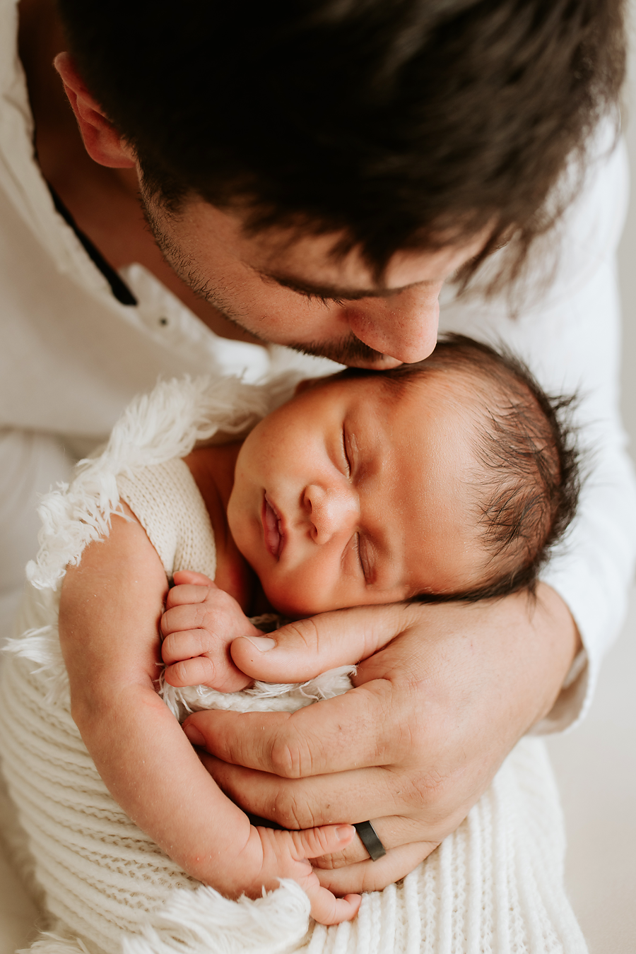 Sweet close-up shots of parents cuddling with their newborn baby.