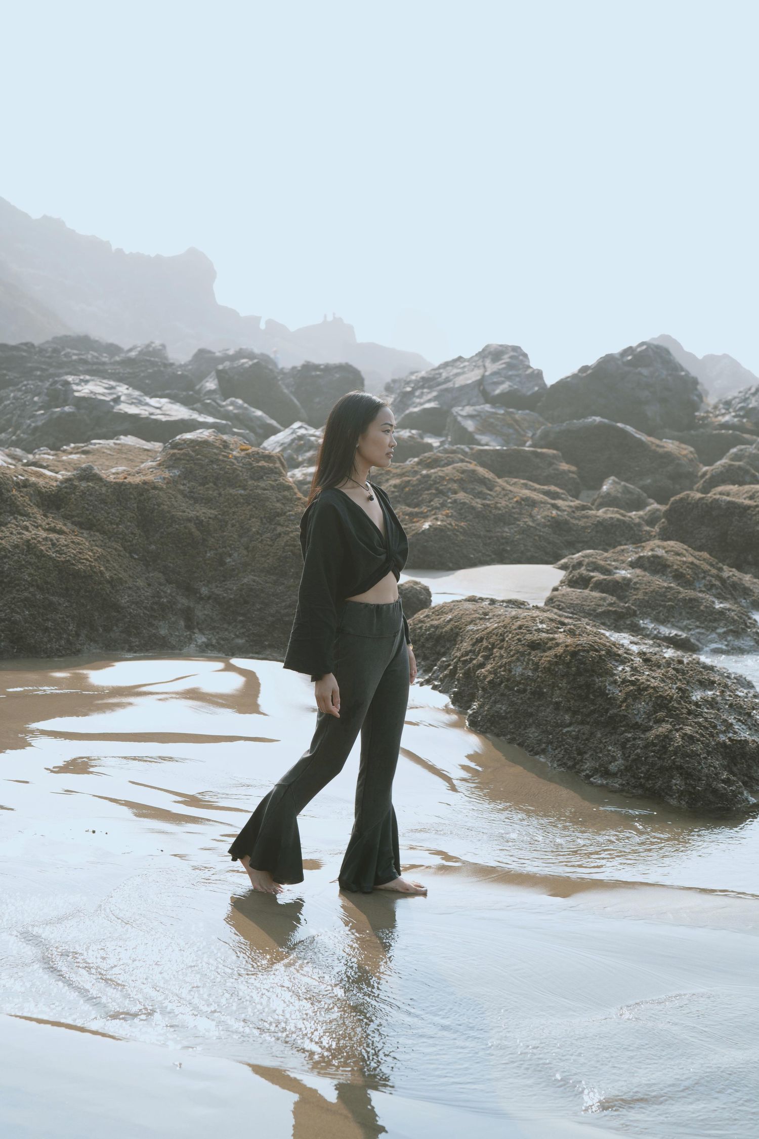 Sanetra Longno photo of Cassandra Lam barefoot on the watery sands of Ecola State Park