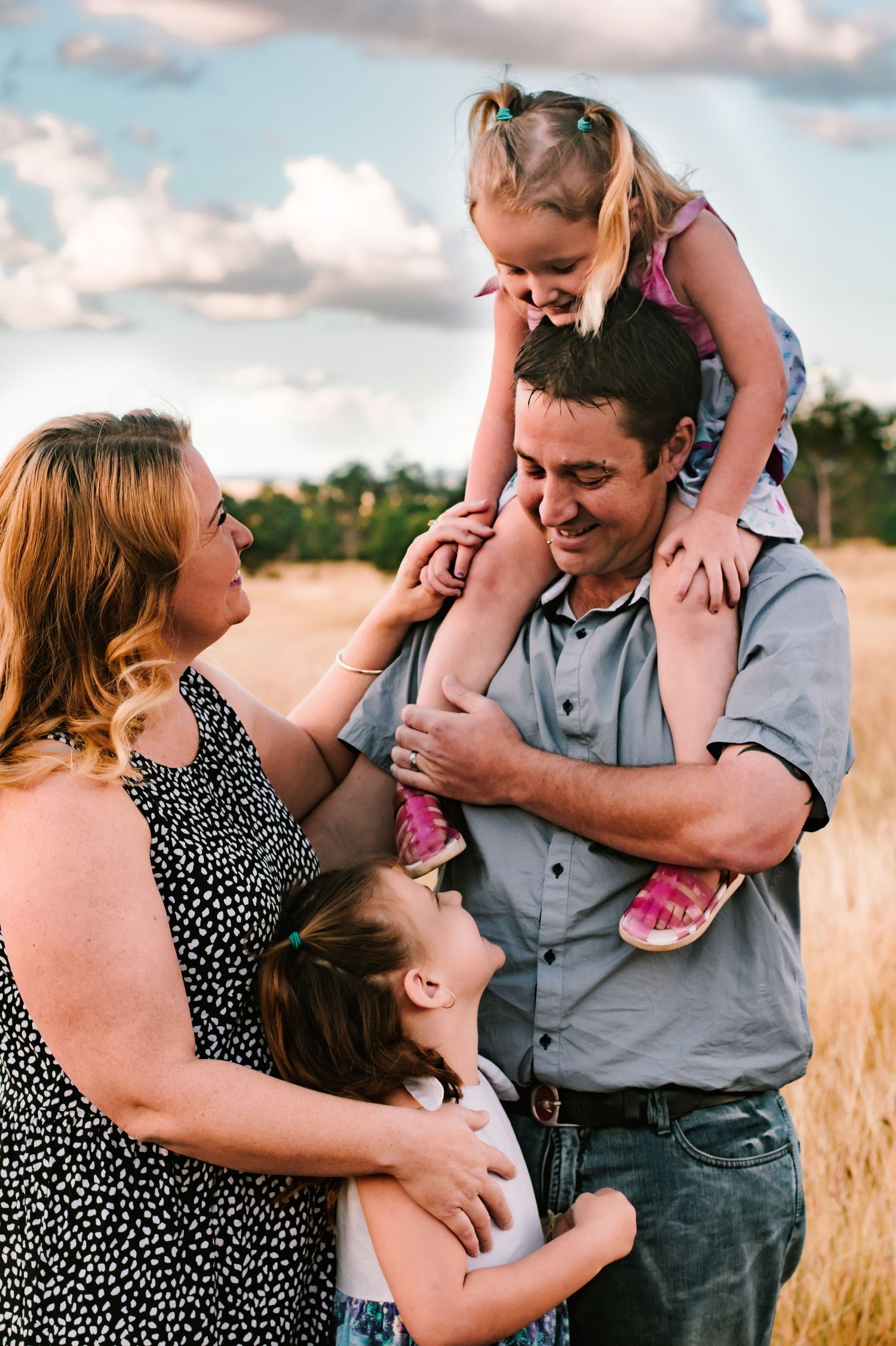 Loving couple shares tender moments together in a golden field during sunset.
