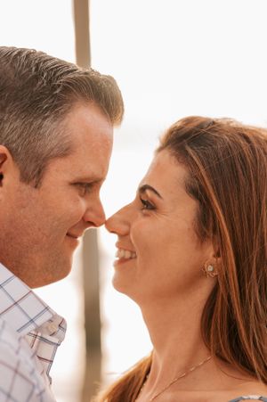 Intimate close up portrait of couple sharing romantic moment at beach.