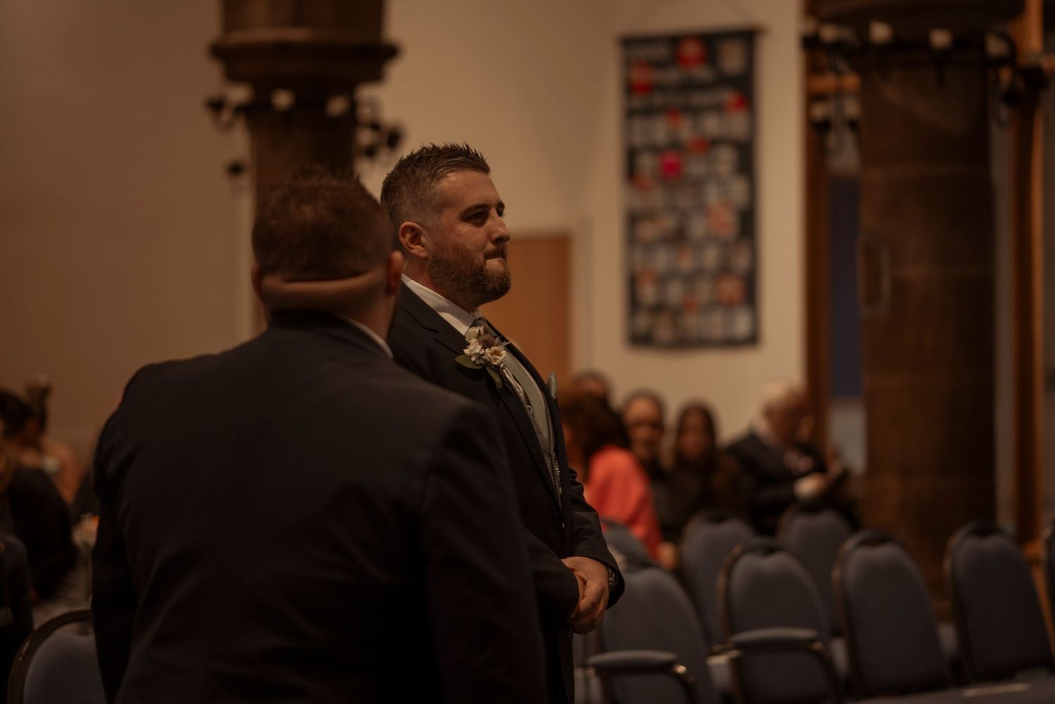 groom waiting anxiously at the top of the isle