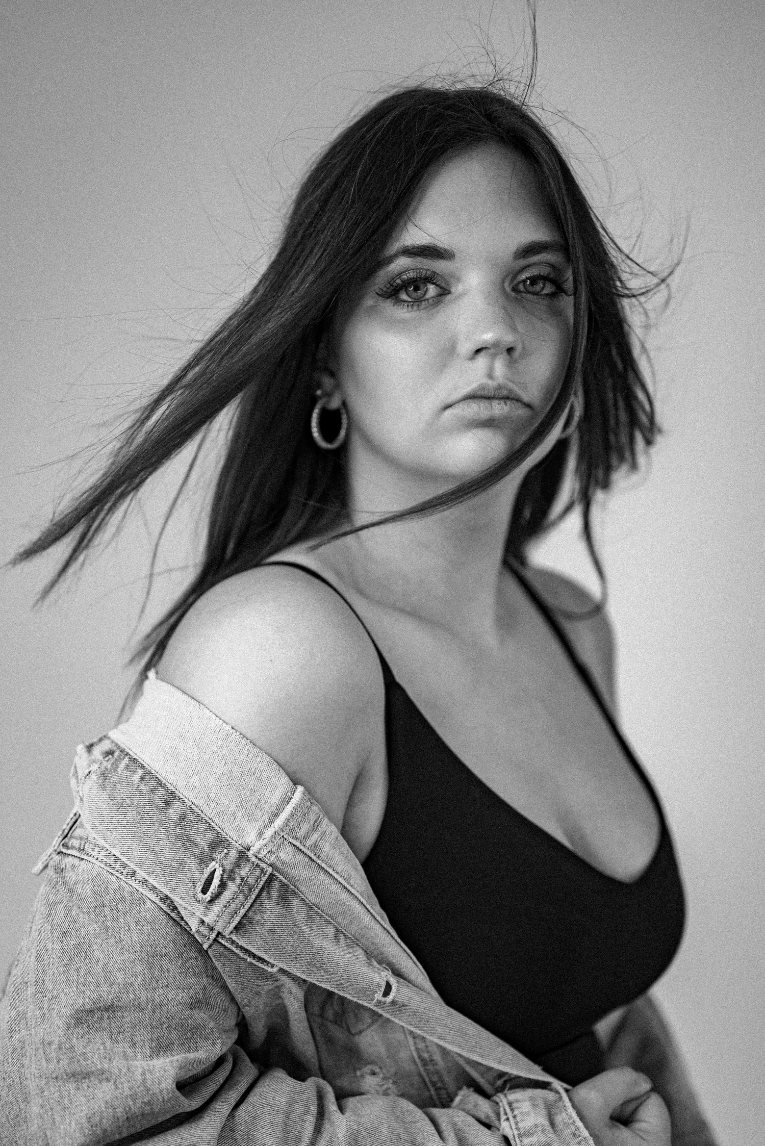 Black and white fashion portrait with natural lighting and denim styling.