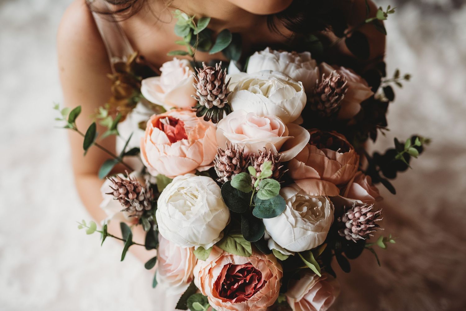 Romantic bouquet of pink and white garden roses with delicate greenery.