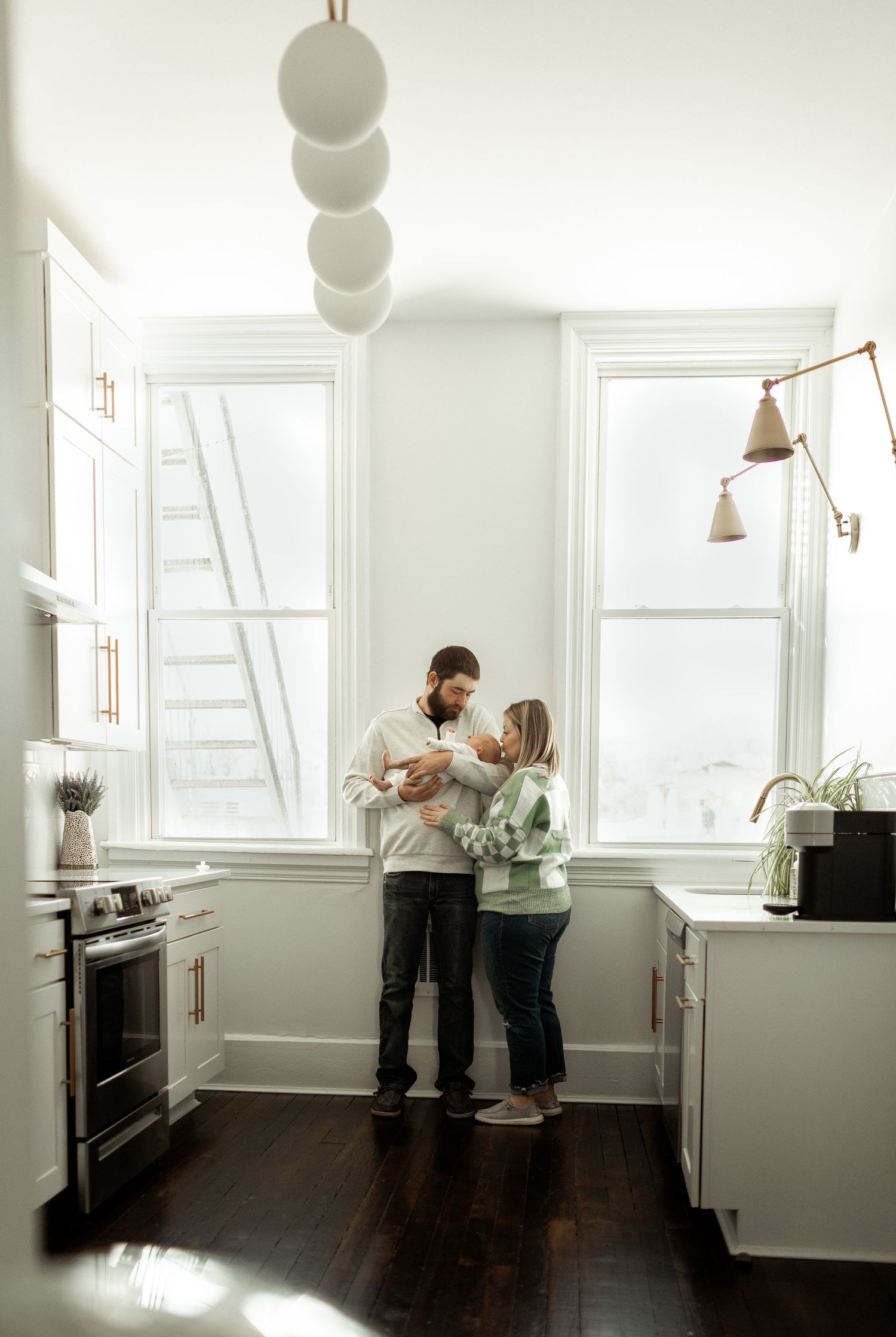 Minimalist kitchen scene with natural light streaming through windows and modern fixtures.