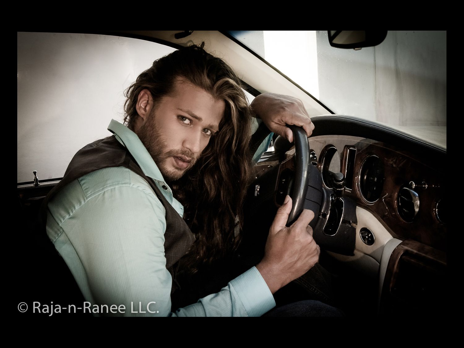 Moody portrait series taken inside a luxury vehicle with dramatic lighting.