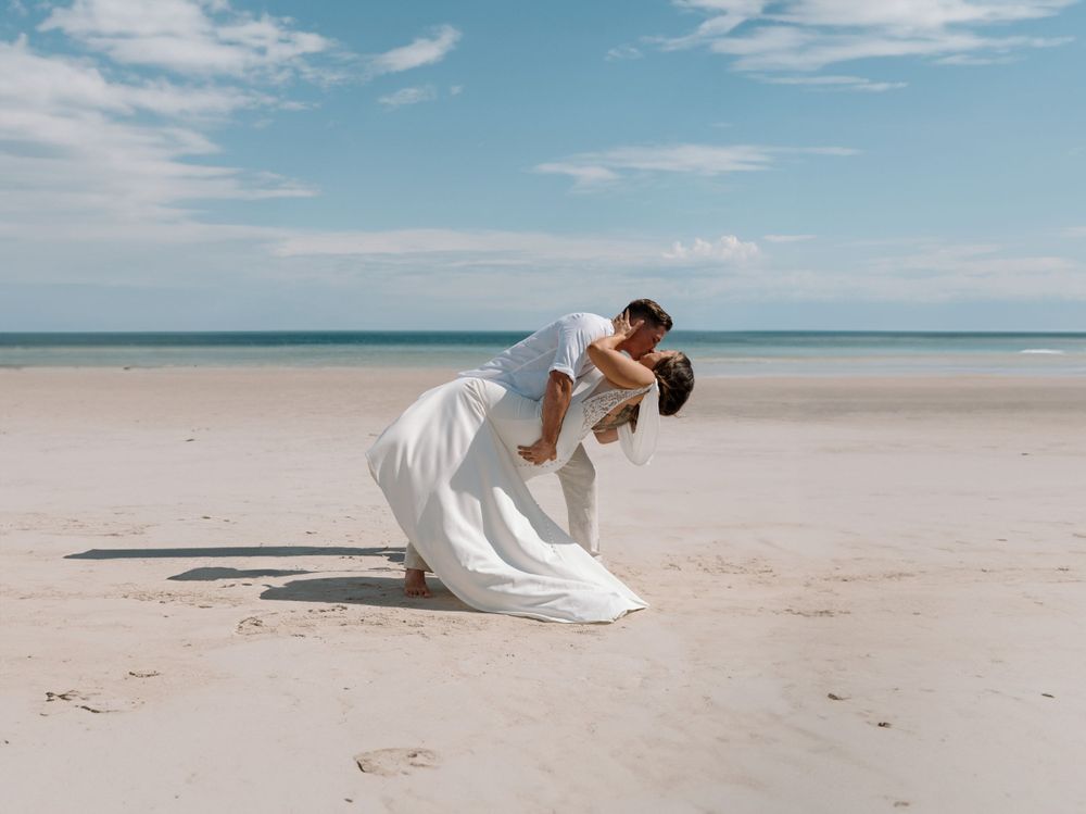 Wedding celebration on a pristine white sand beach under blue skies.