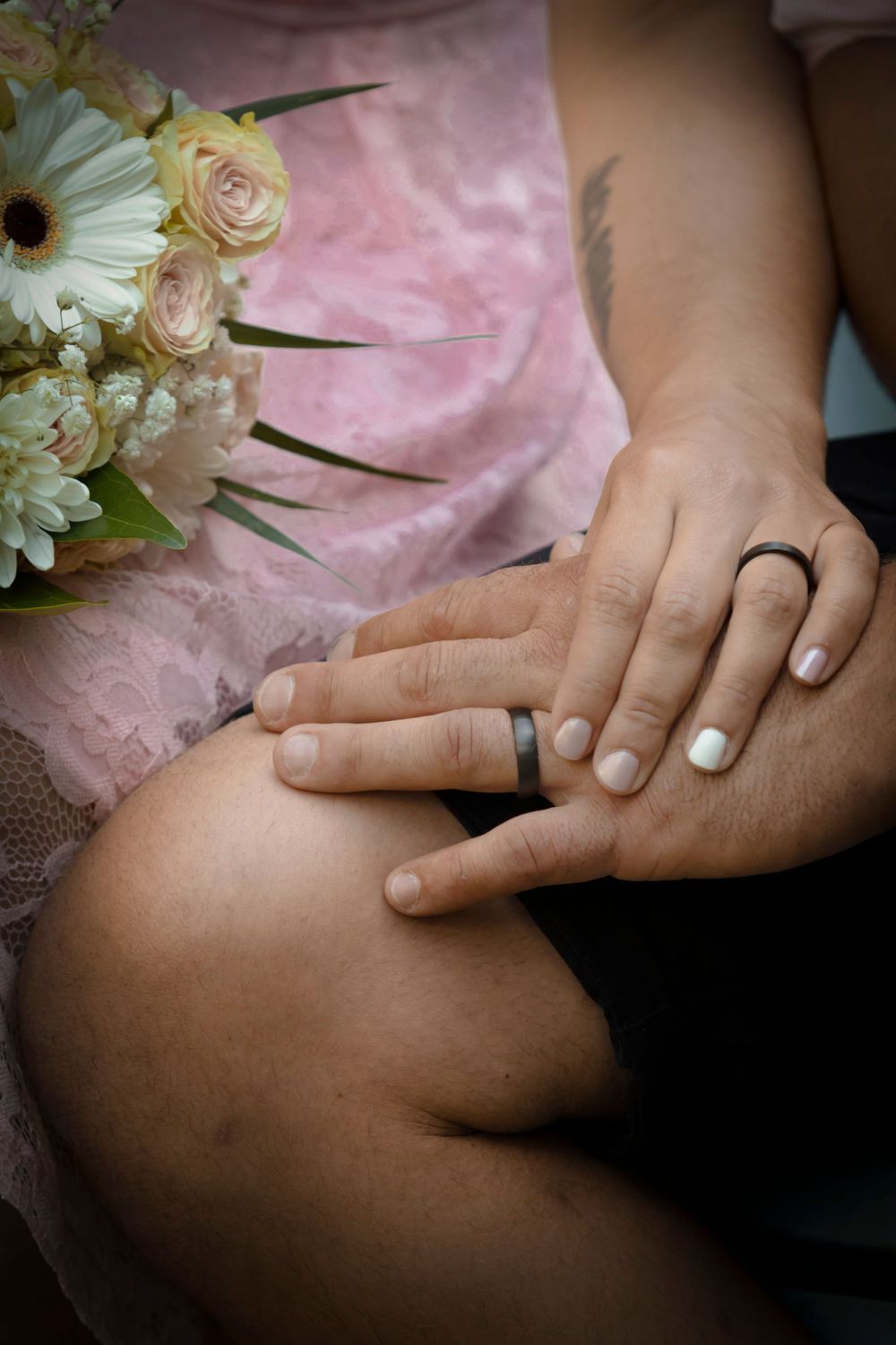 Photo of bride and groom hands with their rings
