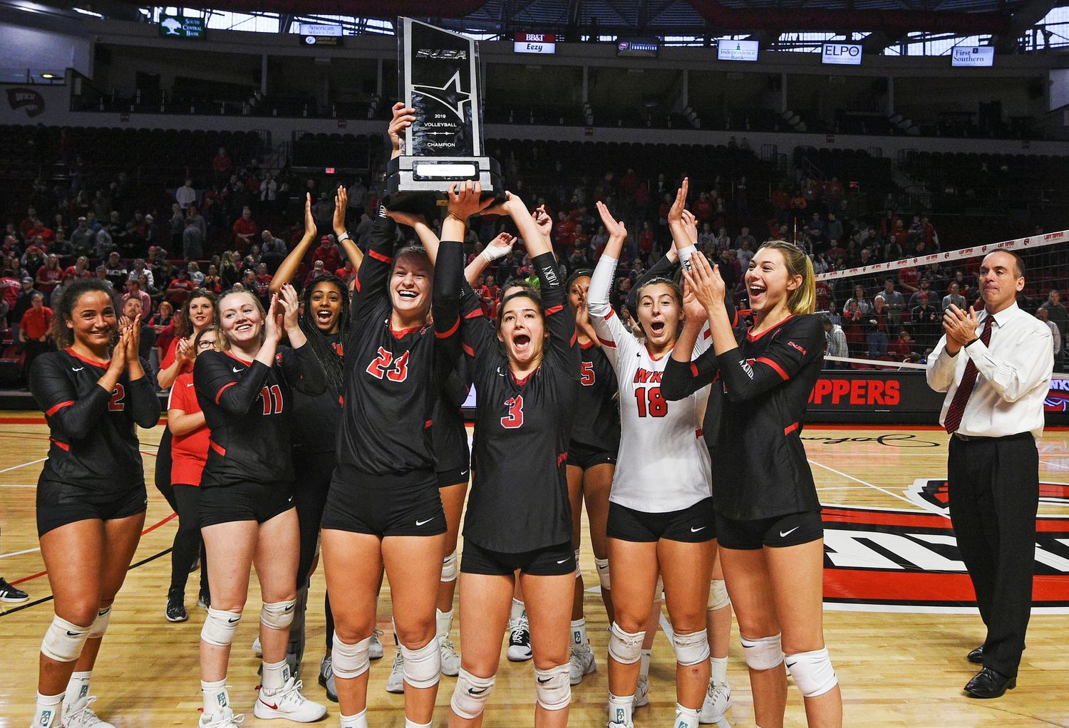 WKU Volleyball with trophy