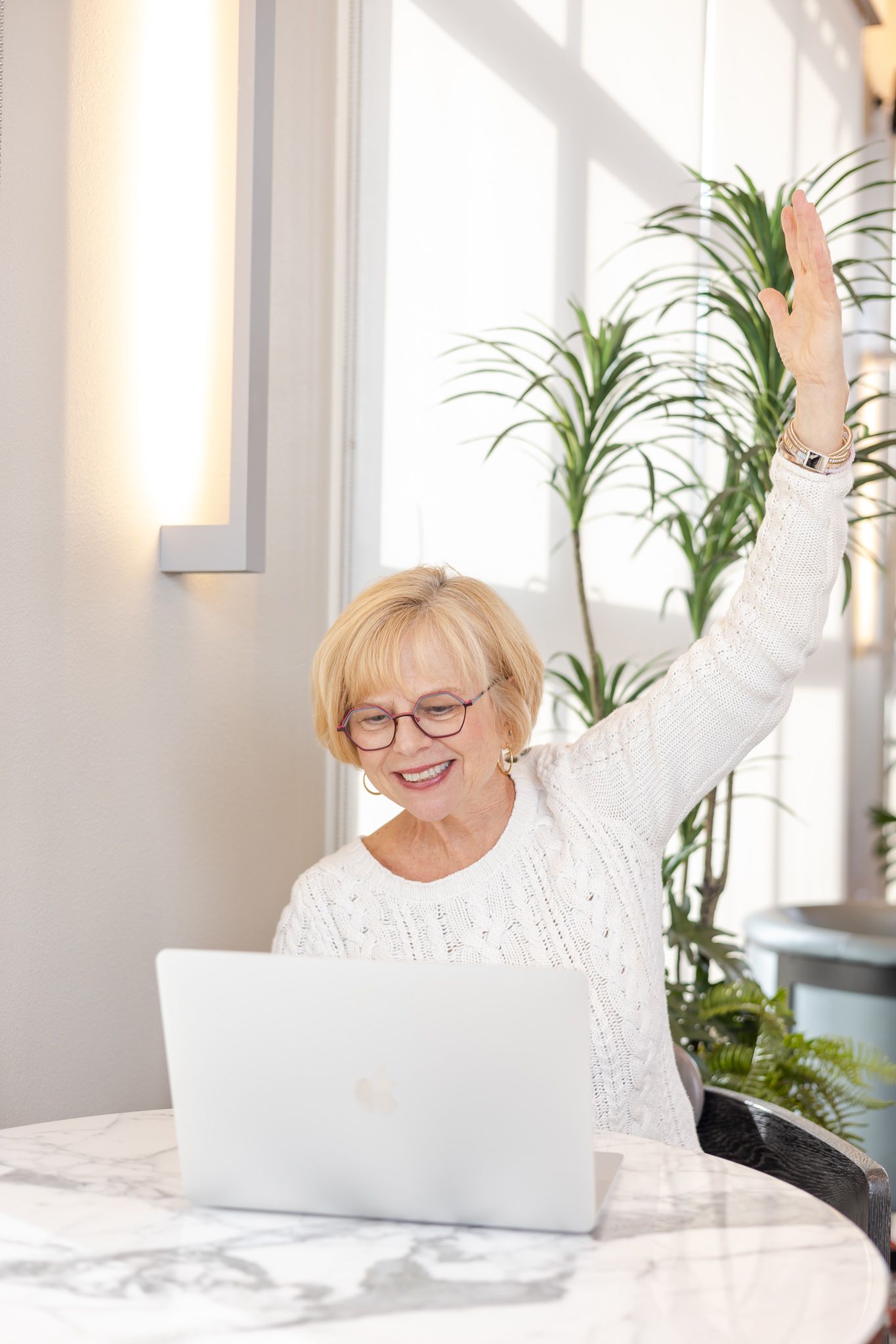 woman doing yoga instructing on computer at table for headshots in Woodinville, WA
