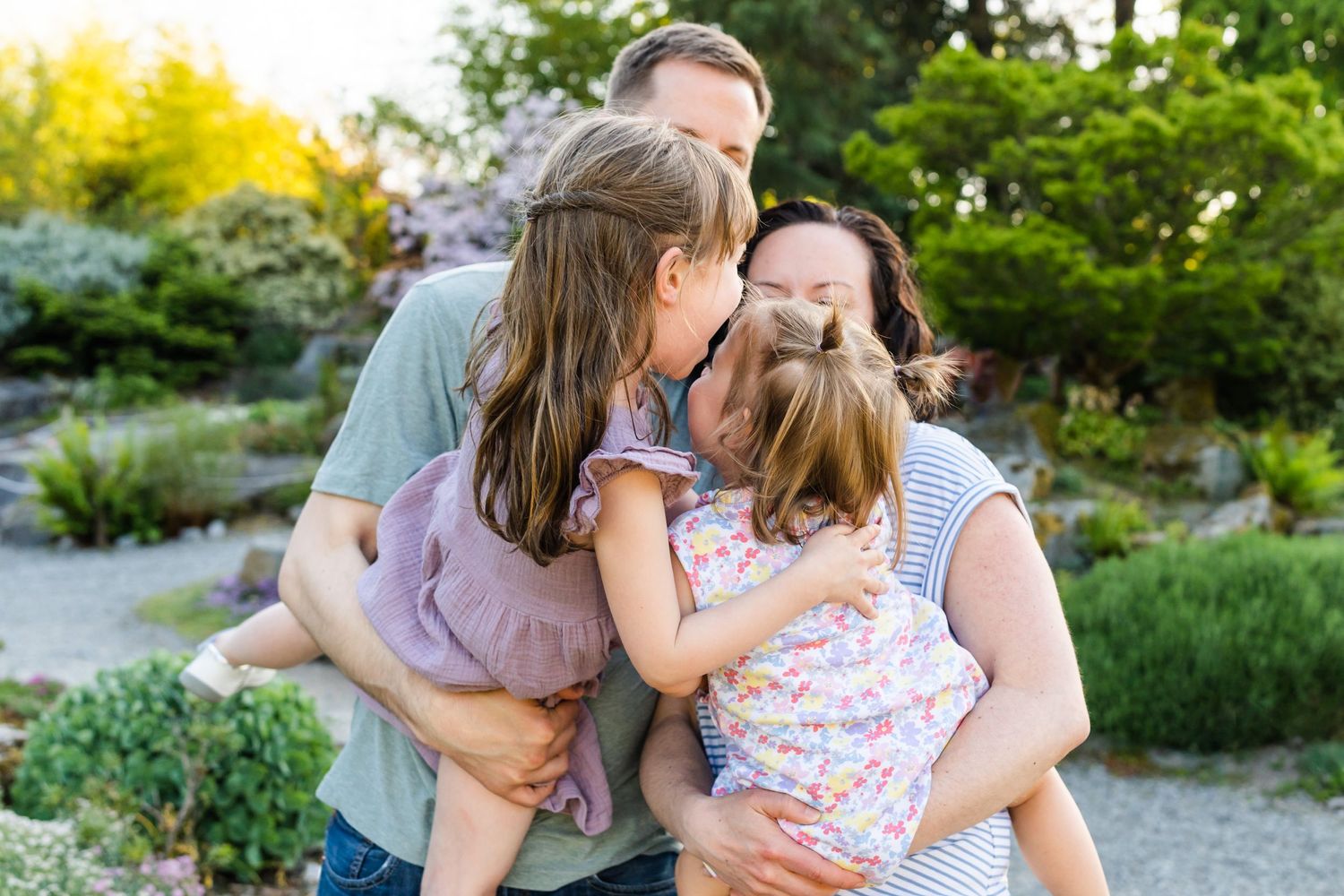 Family shares a hug at Bellevue Botanical Garden in the summer.