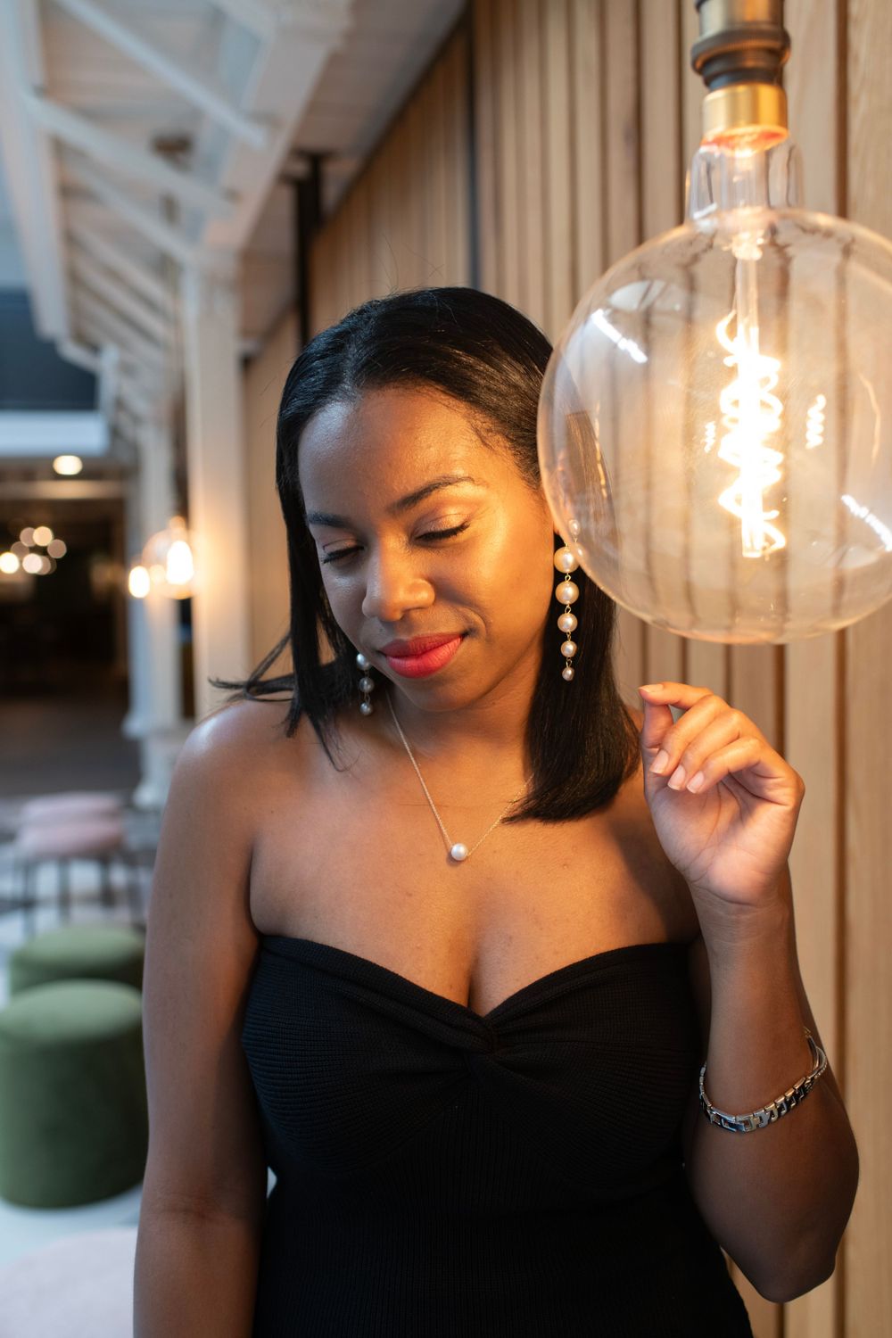 Girl poses with vintage lightbulb in eclectic downtown Columbia apartment