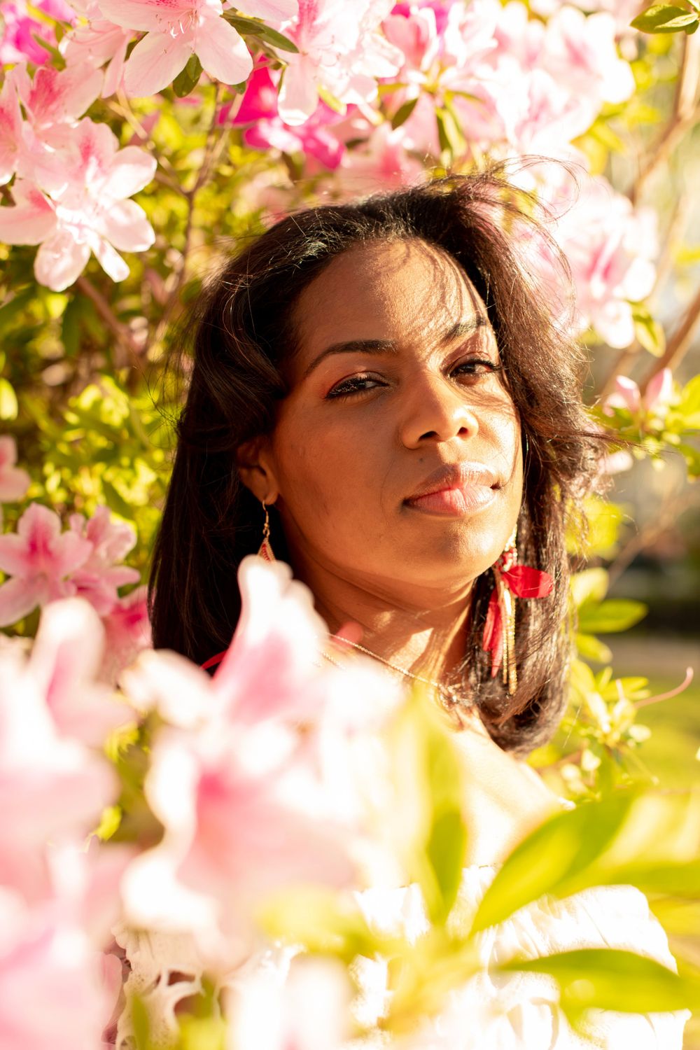 Girl poses in the sun and flowers at a park in Columbia, SC