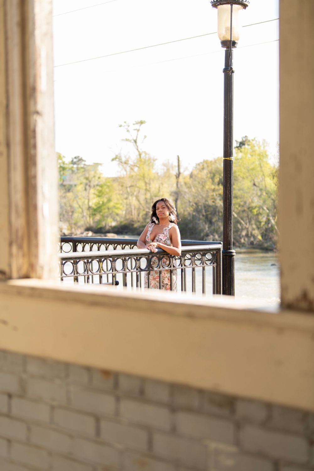 Girl poses on overlook by river in downtown columbia, sc