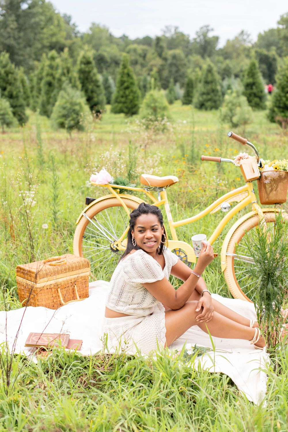 Girl sits in a field with a yellow bike in Gilbert, SC
