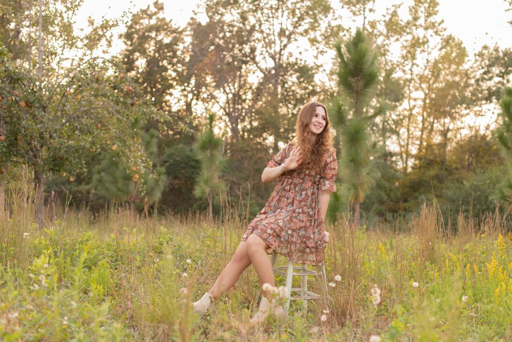 Girl sits in a wild grass field in Gilbert, SC