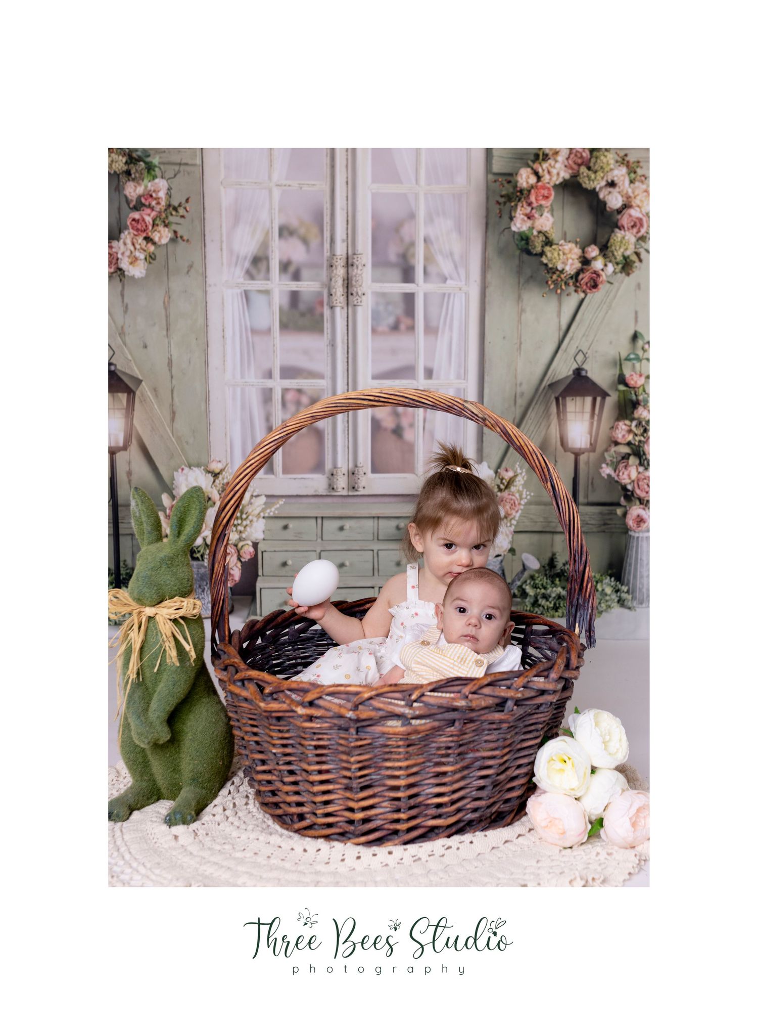 Vintage-style Easter setup with wicker basket and floral wreath decorations.