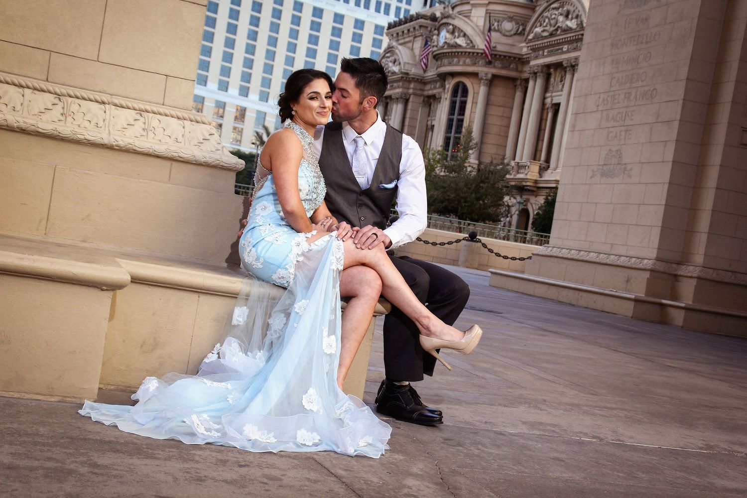 A romantic pose on a Las Vegas balcony with an elegant light blue wedding dress.