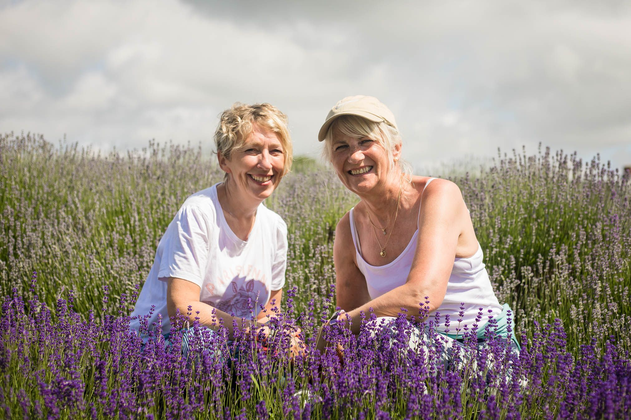 Two women happy to pose in front of the camera at Cotswold Lavender fields.