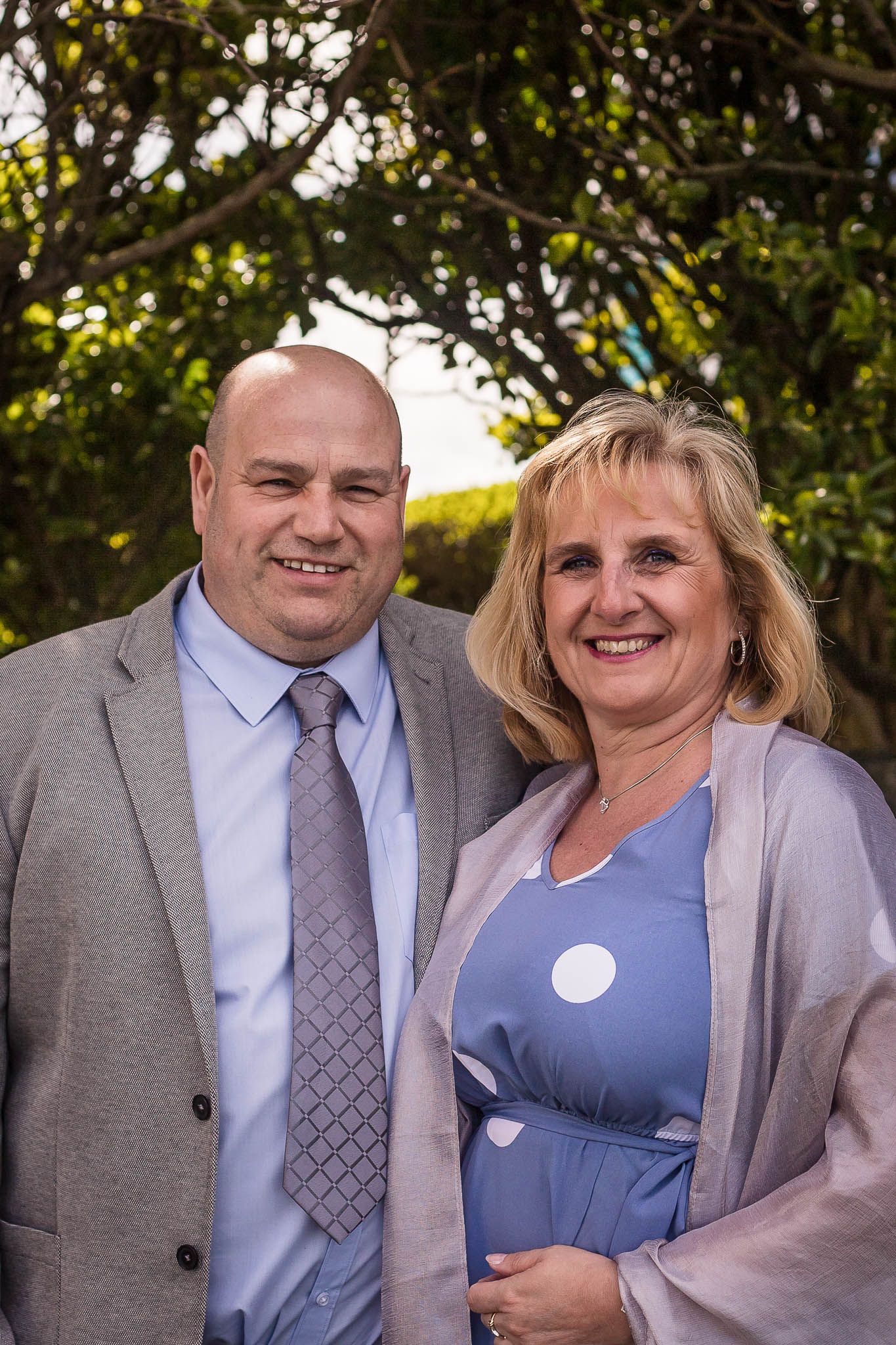 Happy couple posing for the camera at a wedding in Wales