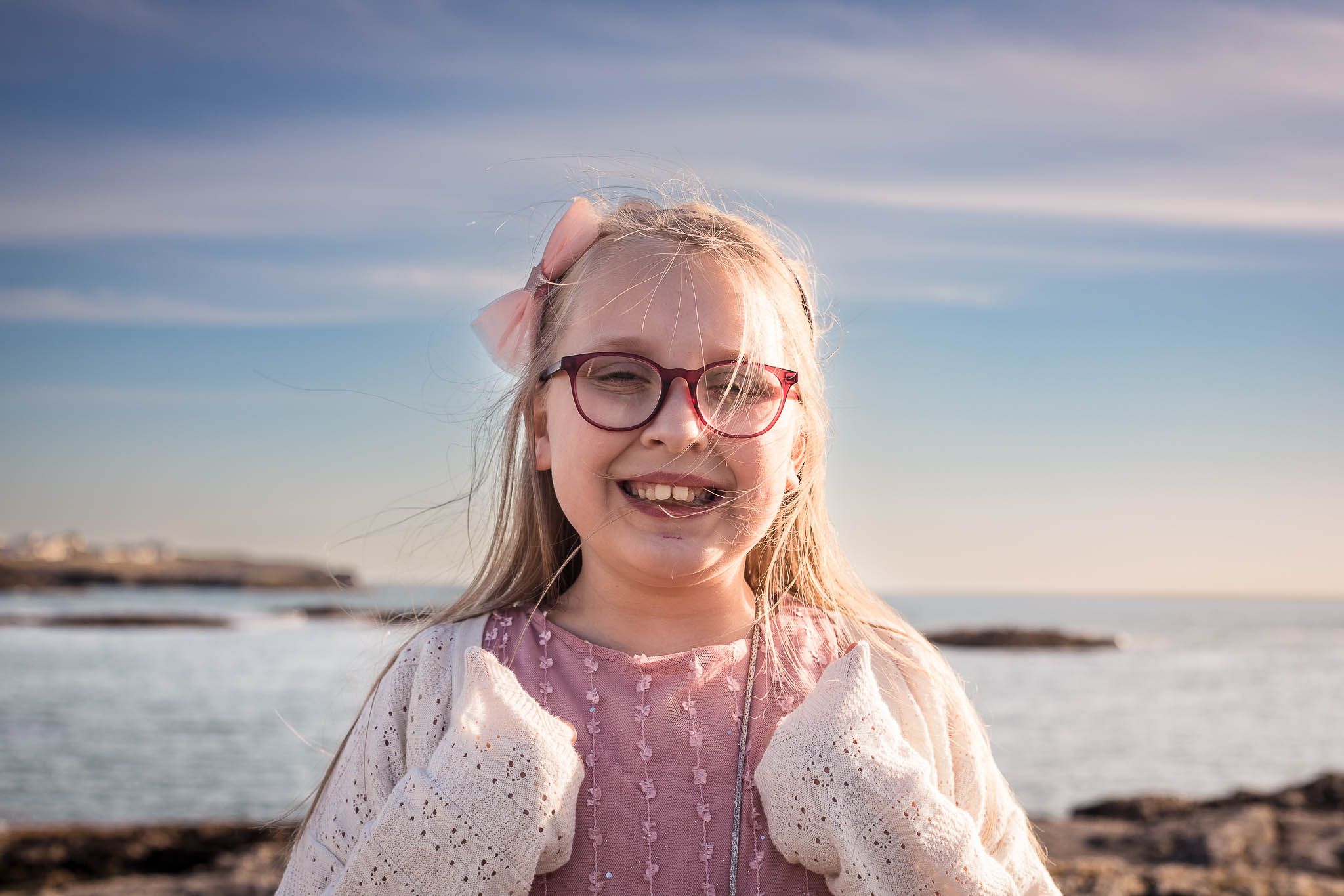 Thumbs up from this happy beach goer wearing wedding attire for a wedding in Angelsey.