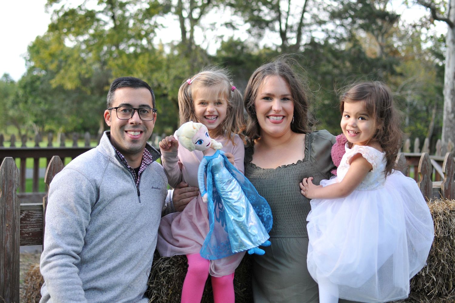 Family near fence for fall pictures