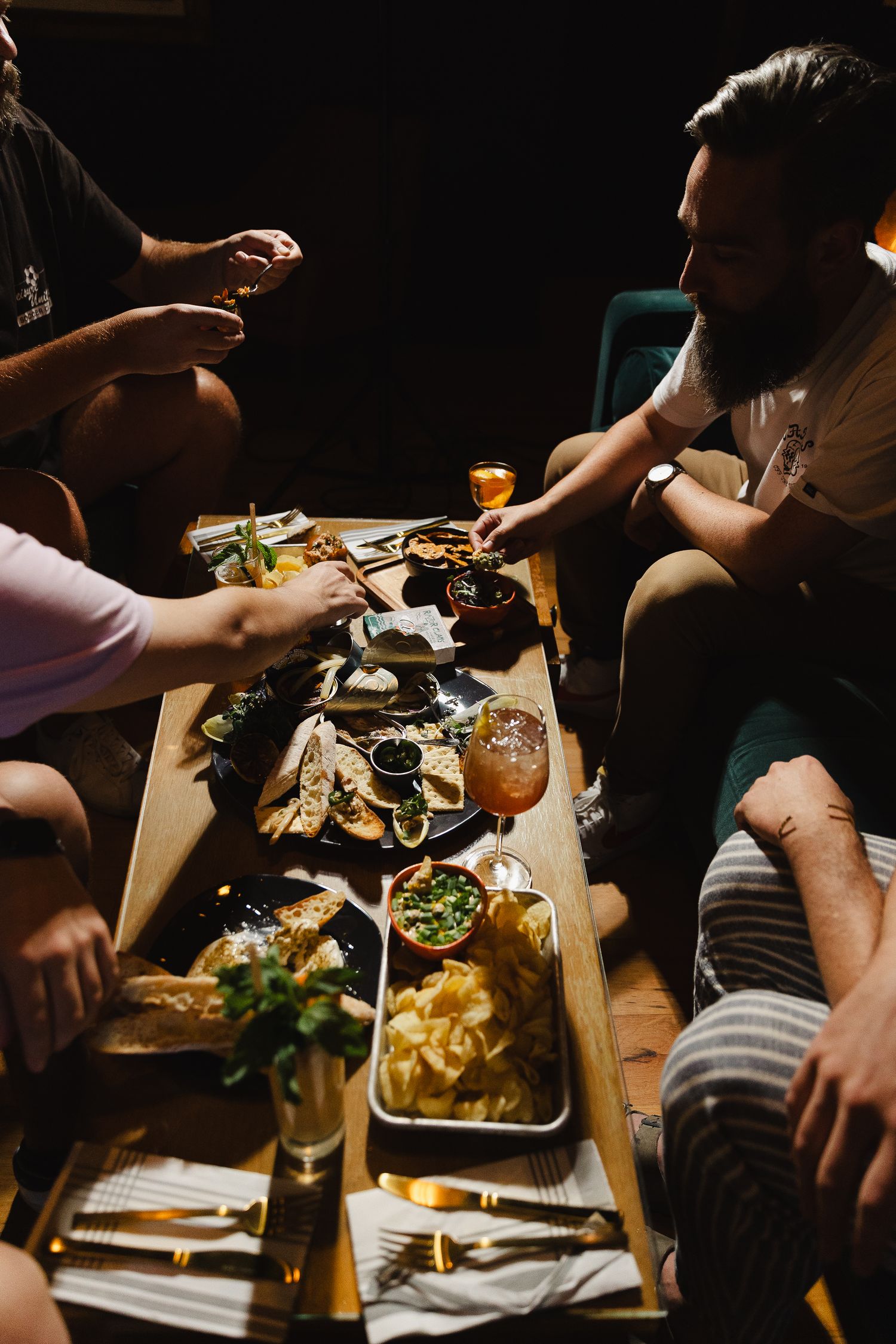 Guests sharing a family-style meal at an event, food and event photography by Konrad Odhiambo.