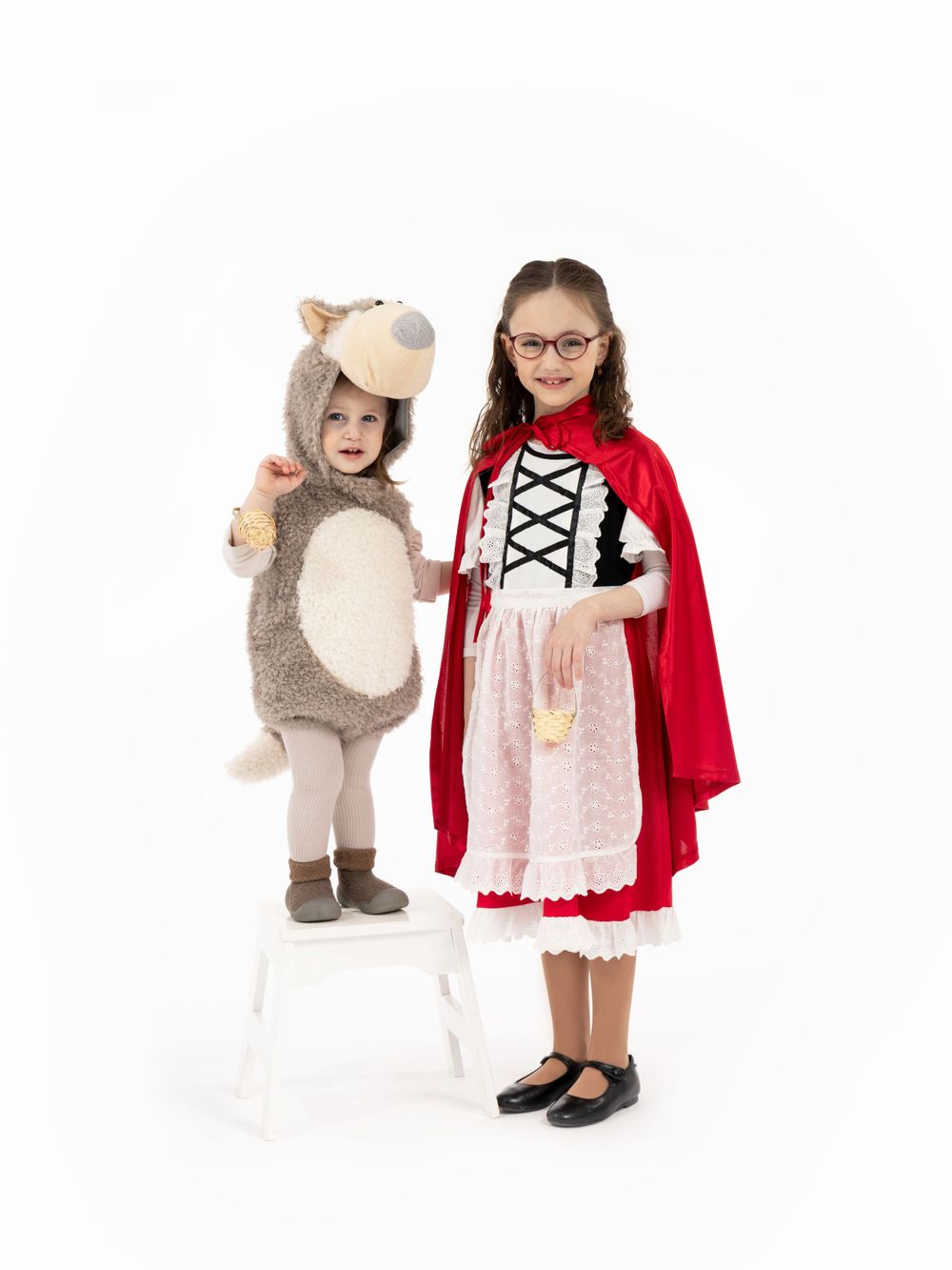 Two children in fairy tale costumes - one as Little Red Riding Hood and one as Big Bad Wolf.