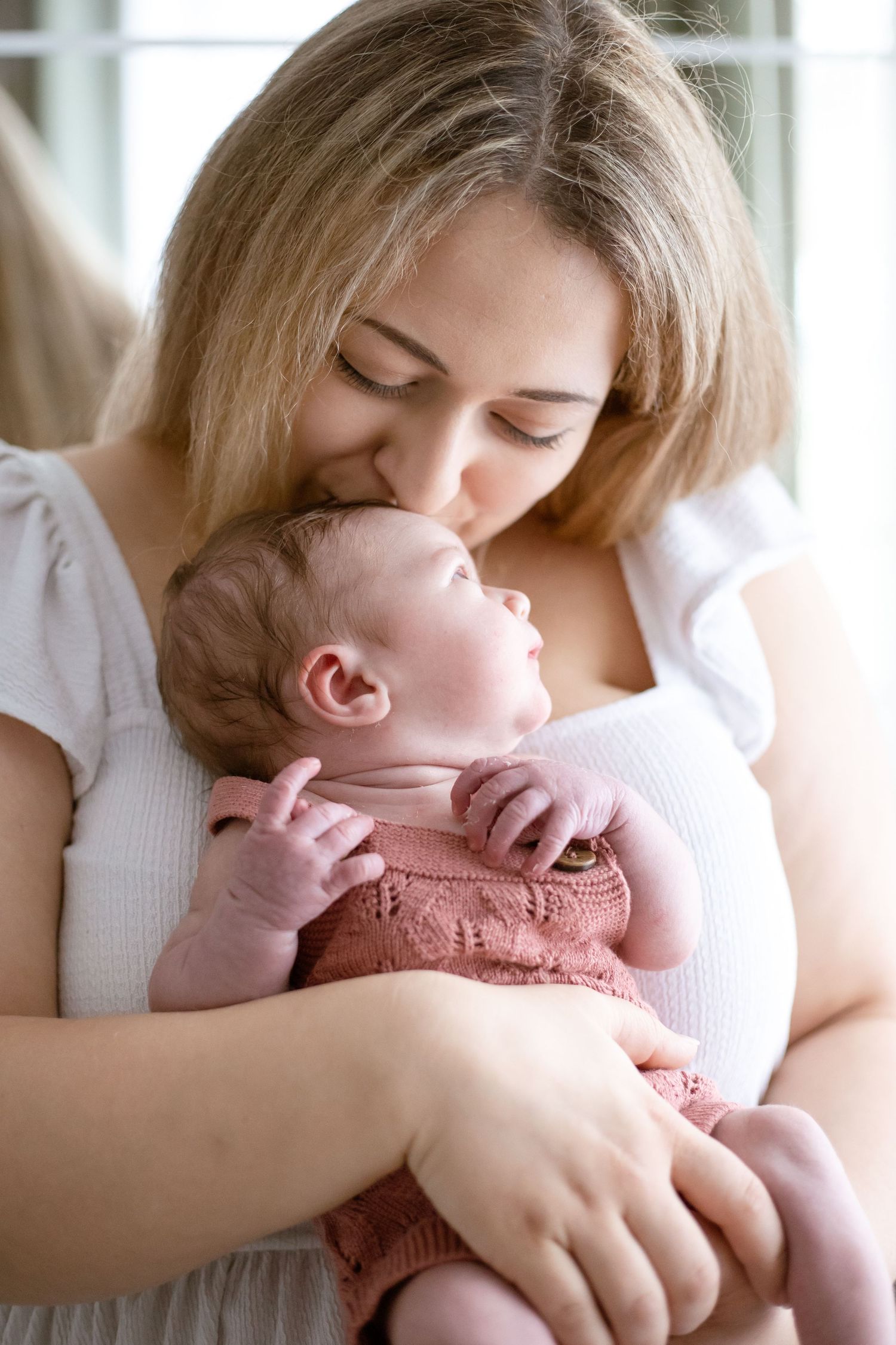 newborn baby girl in mothers arms