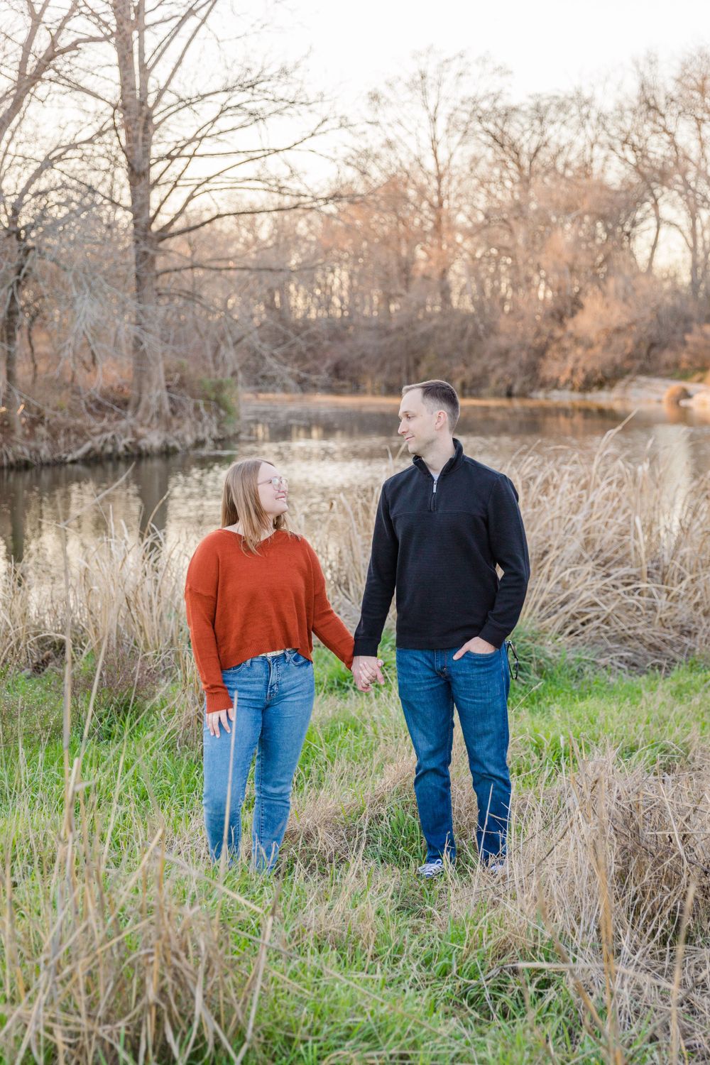engagement portrait in tall grass field in McKenny Falls State Park