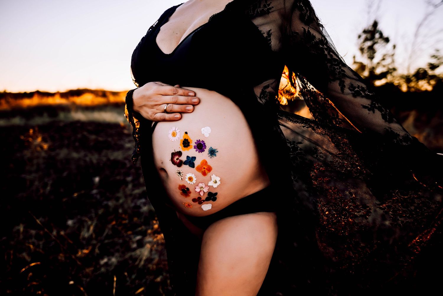 Delicate floral temporary tattoos decorating skin during an outdoor photoshoot.
