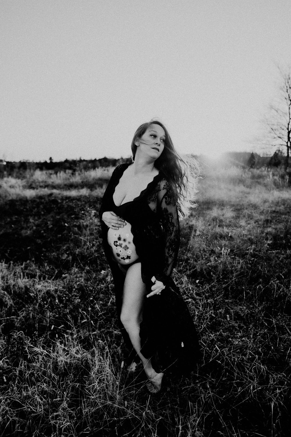 Black and white portrait capturing emotional movement in a natural setting.