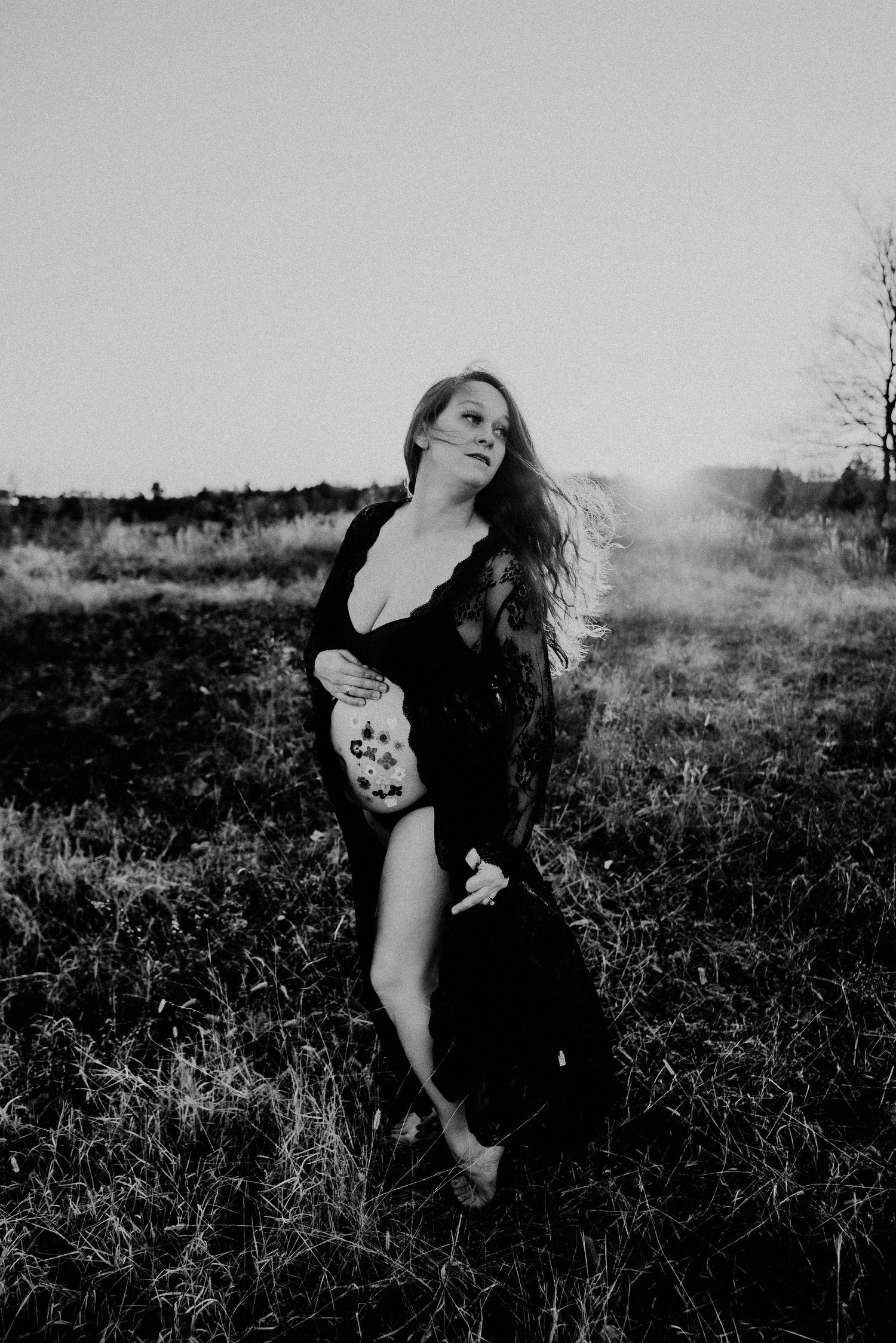 Black and white portrait capturing emotional movement in a natural setting.