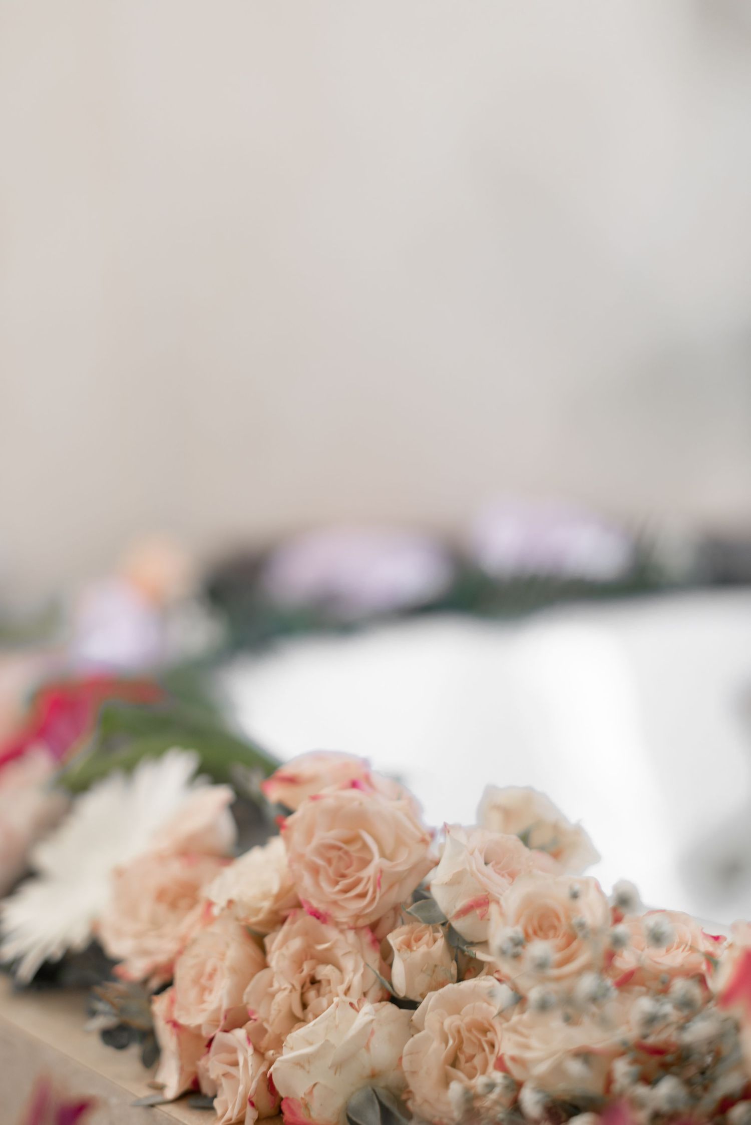 Delicate peach and blush roses arranged in soft romantic floral display.
