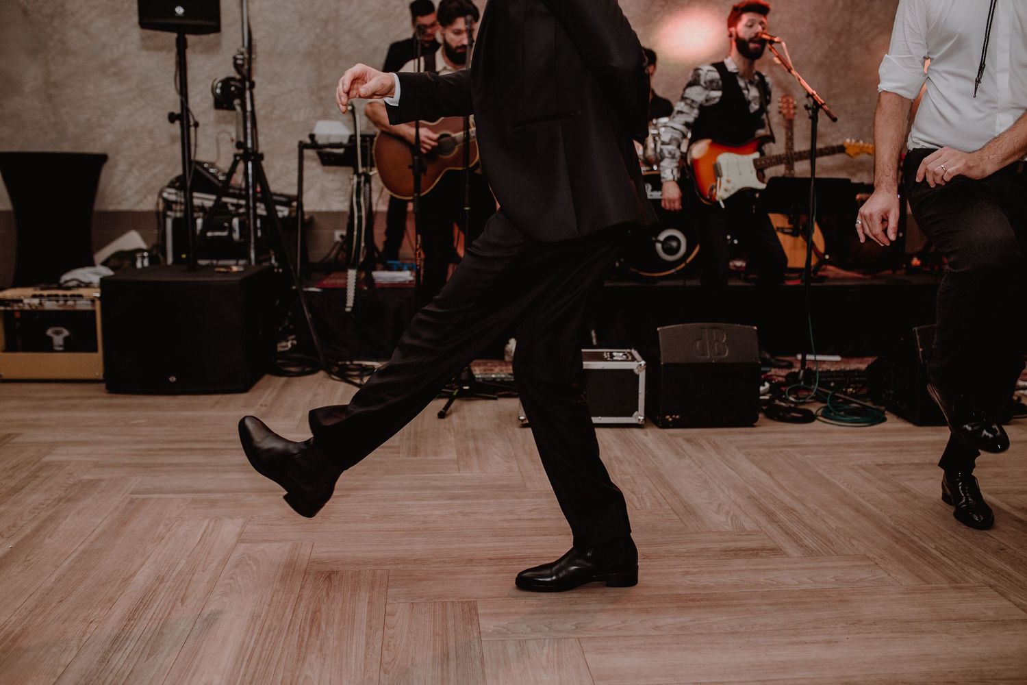 Groom on the dance floor rock and rolling and celebrating their wedding captured in wedding photography