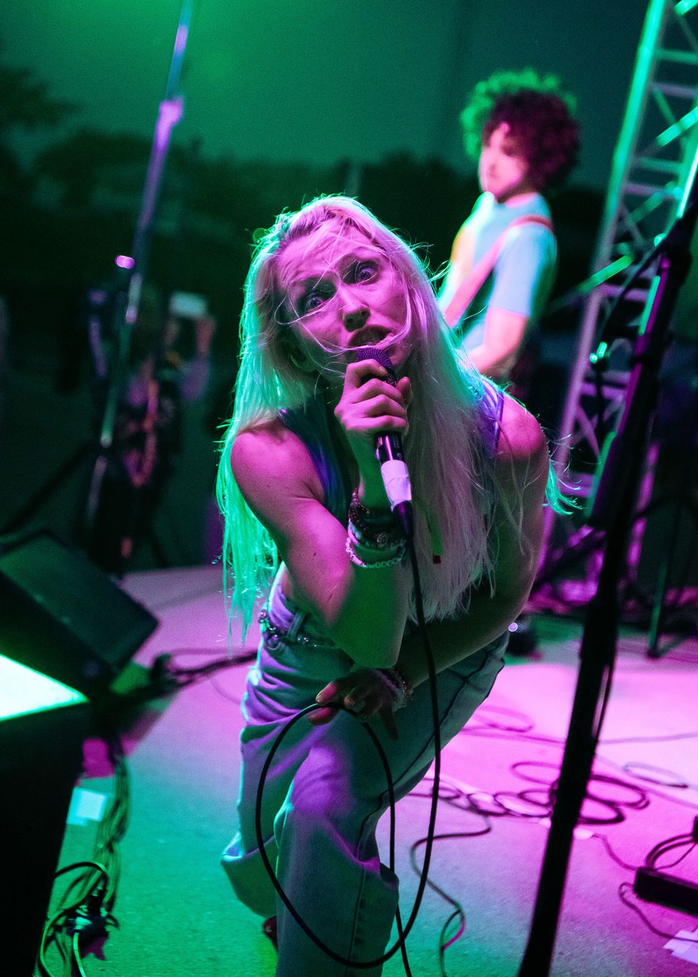 Nikki of Hooked Like Helen looking at the camera holding the microphone to her mouth