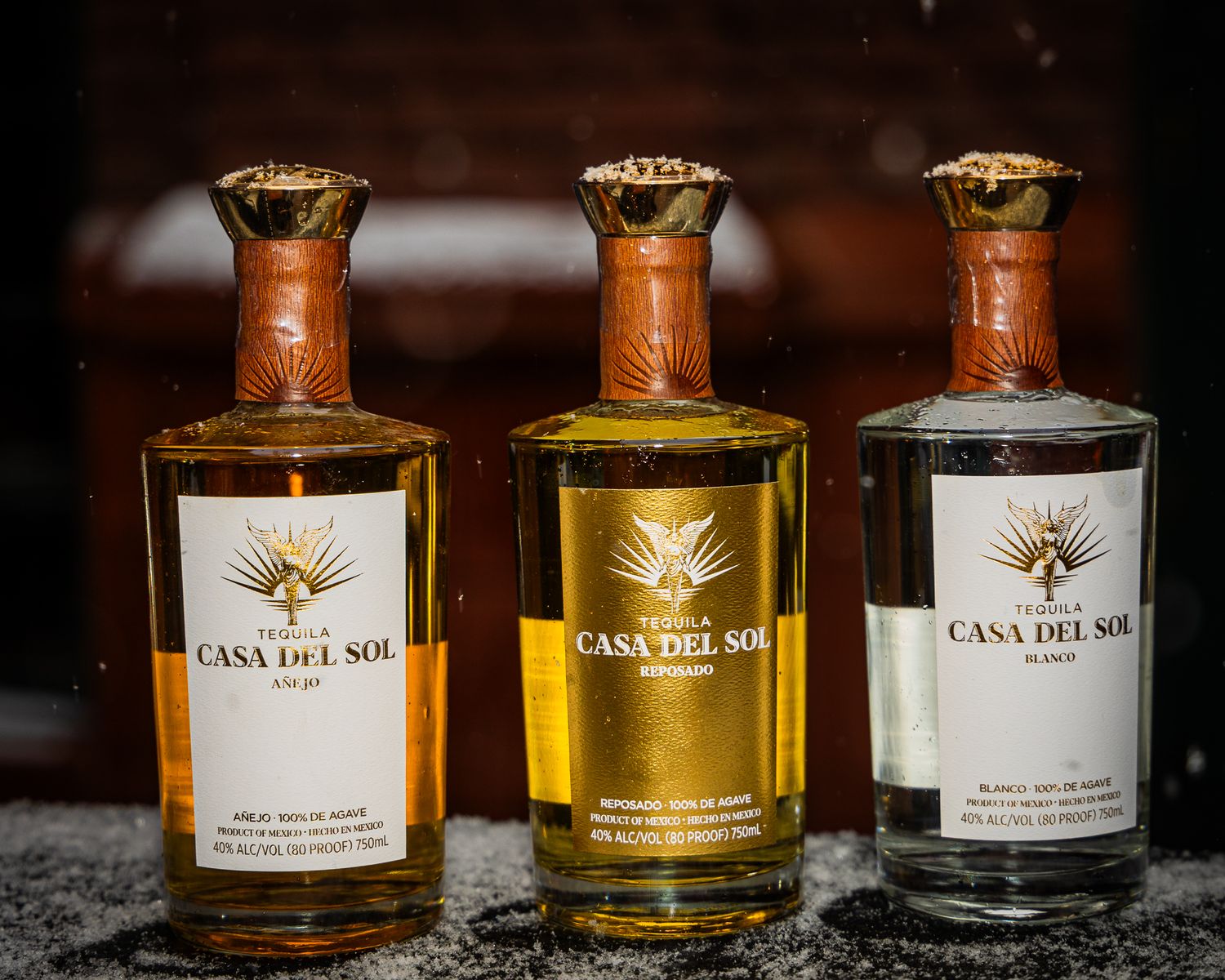 Three elegant bottles of Casa Del Sol tequila in different varieties displayed against a dark background.
